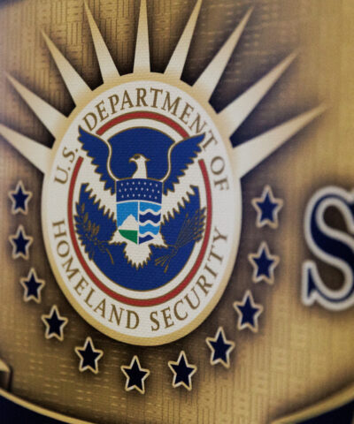 FILE PHOTO: The seal of the U.S. Department of Homeland Security is printed on a sign during a U.S. Immigration and Customs Enforcement (ICE) two-day job fair in Texas to help fill vacancies for deportation officers and attorneys, in Arlington, Texas, U.S. August 26, 2025. REUTERS/Shelby Tauber/File Photo