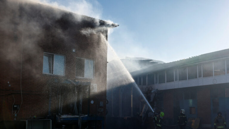 Firefighters extinguish fire at the building of a branch of Ukrainian postal services which was damaged during a Russian missile and drone strike, amid Russia's attack on Ukraine, in the town of Brovary, Kyiv region, Ukraine March 14, 2026. REUTERS/Valentyn Ogirenko