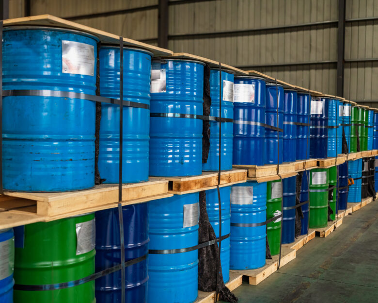 Blue Metal Oil Barrels Stacked In A Warehouse
