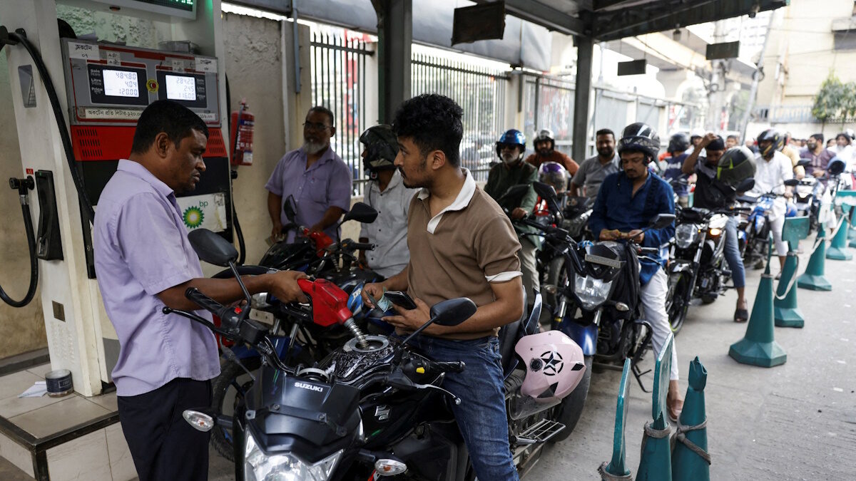 FILE PHOTO: A man refuels his motorcycle at a fuel station, as concerns grow over fuel supplies following U.S.-Israel conflict with Iran, in Dhaka, Bangladesh, March 6, 2026.