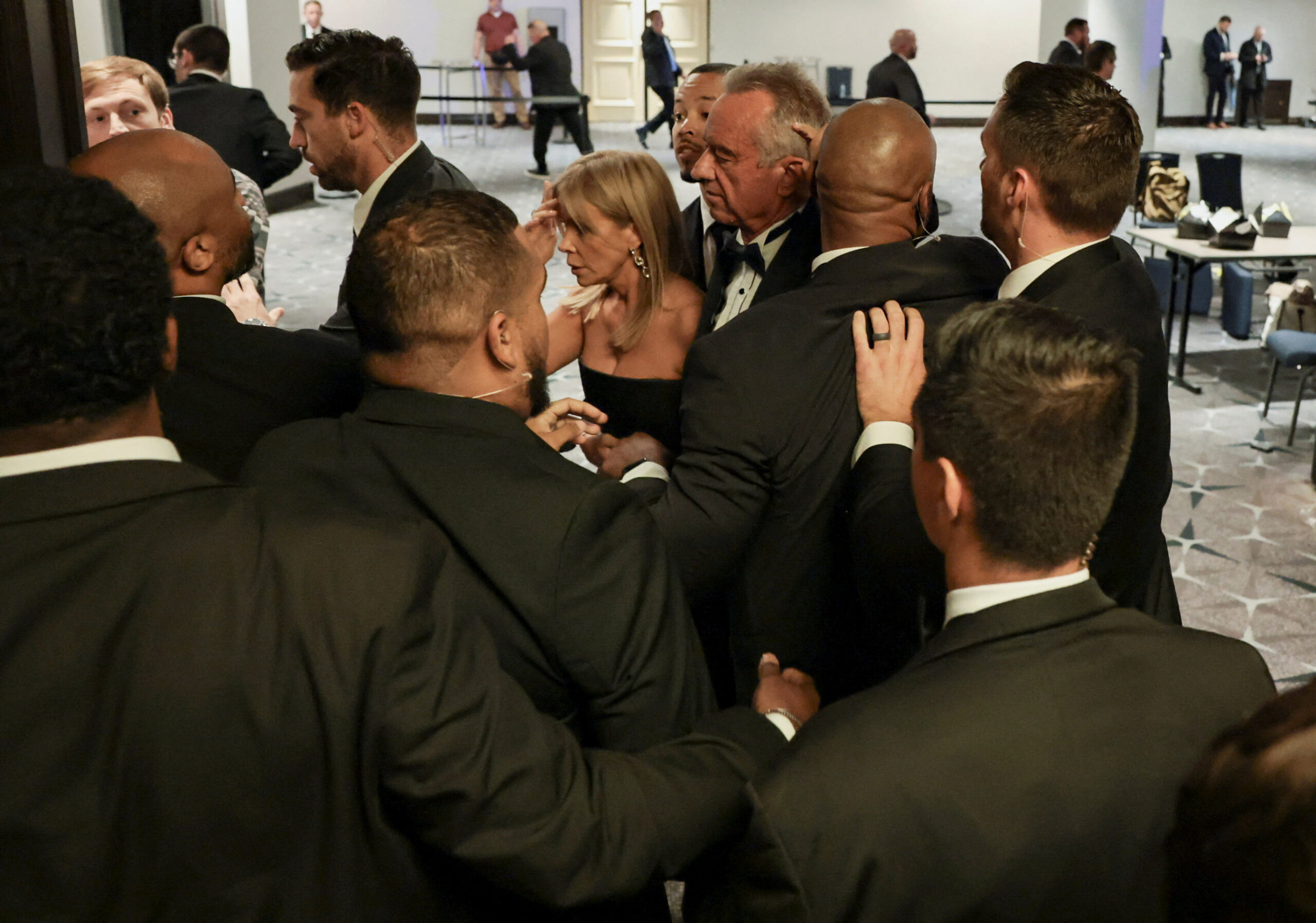 Security officials evacuate U.S. Health and Human Services (HHS) Secretary Robert F. Kennedy Jr. and his wife, Cheryl Hines, as a shooter opens fire during the annual White House Correspondents' Association dinner in Washington, D.C., U.S., April 25, 2026. REUTERS