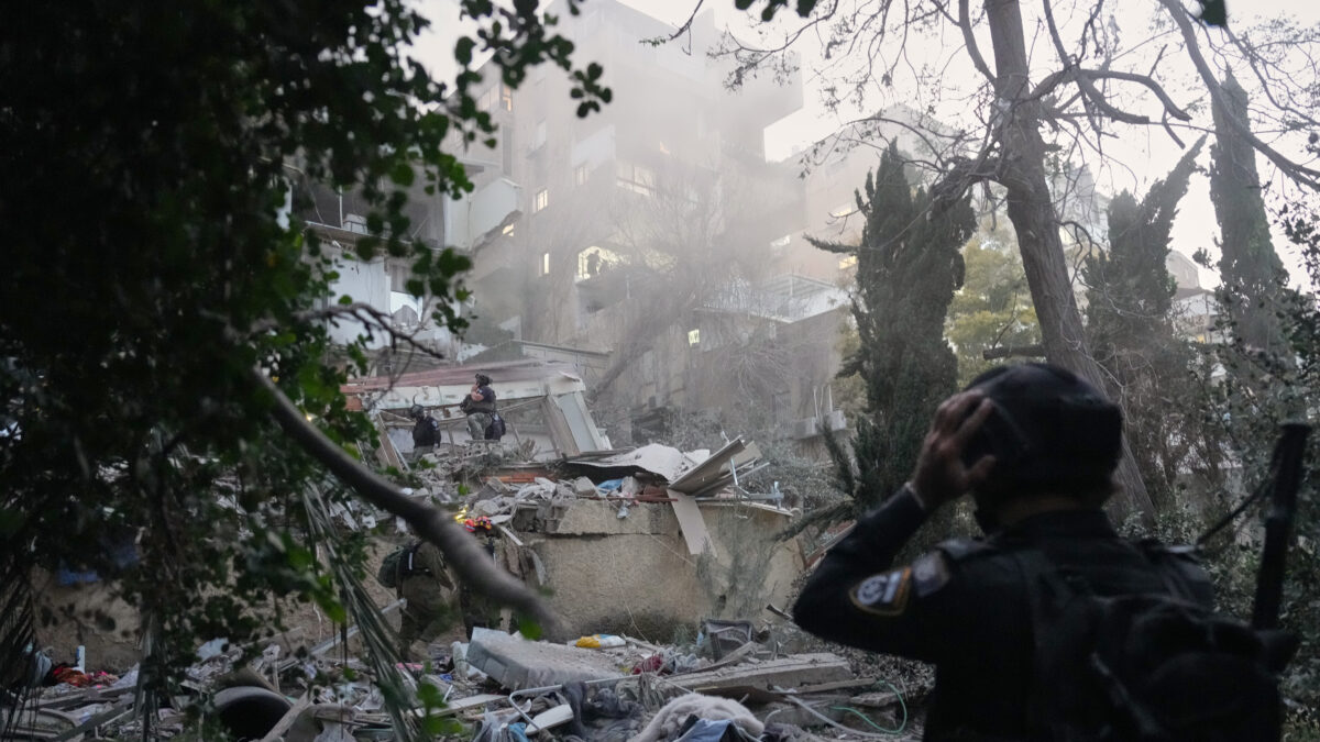 Israeli security forces and rescue teams work amid the rubble of a residential building struck by an Iranian missile in Haifa, Israel, Sunday, April 5, 2026. (AP Photo