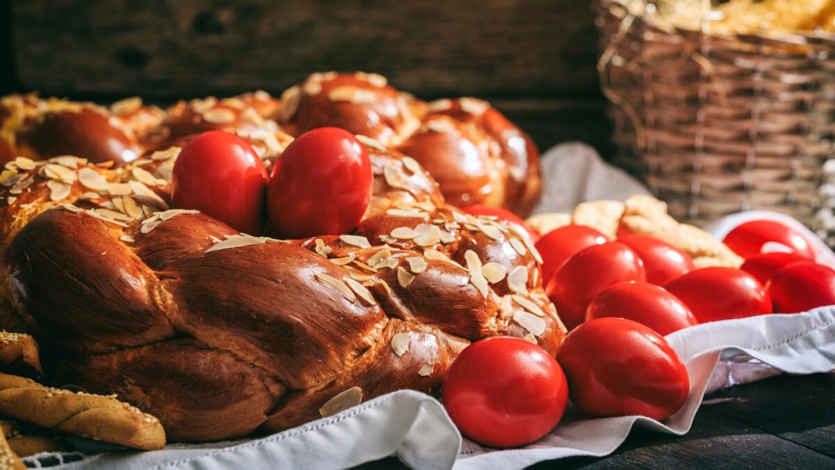 Easter traditional bread and red eggs on a table