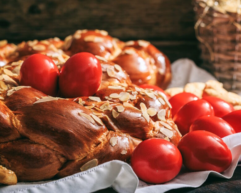 Easter traditional bread and red eggs on a table