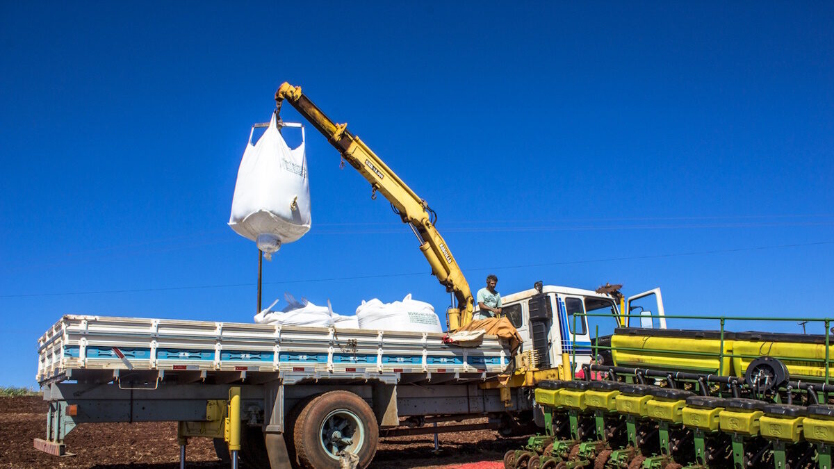 Rolandia PR, Brazil, February 28, 2013. Worker carry an agricultural machine with fertilizer to be used along with corn planting in Rolandia, northern region of Parana State.