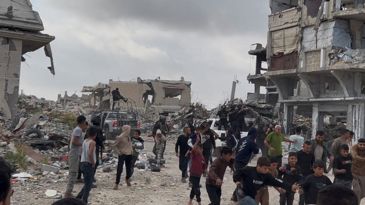 People react near Palestinians fighters after clashes with Israeli-backed militia, in Khan Younis, in the southern Gaza Strip, April 20, 2026, in this screengrab obtained from a video. Video obtained by REUTERS THIS IMAGE HAS BEEN SUPPLIED BY A THIRD PARTY. VERIFICATION: - Reuters confirmed the location and the date when the video was filmed have been by the original file metadata. - Buildings, damaged structures, and road layout matched with satellite imagery.