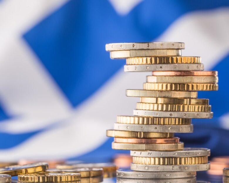 National flag of greece and euro coins - concept. Euro coins. Euro money. Euro currency.