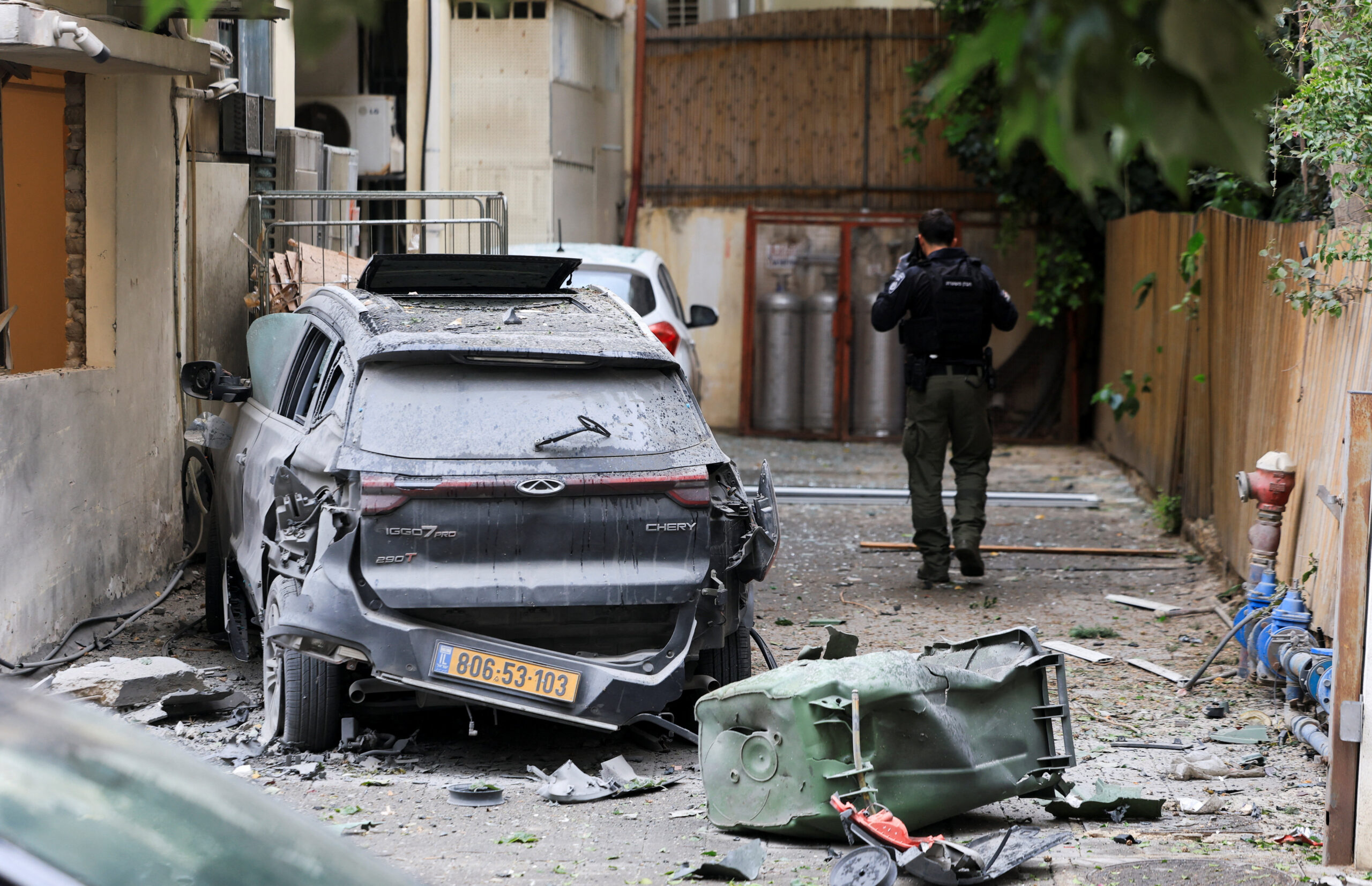 Damaged site after Iran launched missiles towards Israel, amid the U.S.-Israel conflict with Iran, in Tel Aviv An Israeli police officer walks near a wrecked car at the site of damage, caused after Iran launched missiles towards Israel, amid the U.S.-Israel conflict with Iran, in Tel Aviv, Israel April 1, 2026. REUTERS/Ronen Zvulun