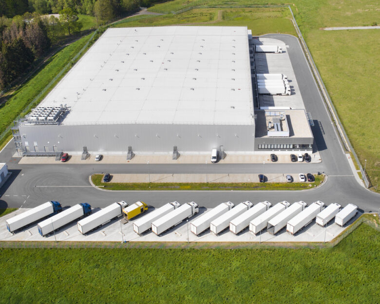 Loading bay, truck parking lot, industrial building, logistics - aerial view