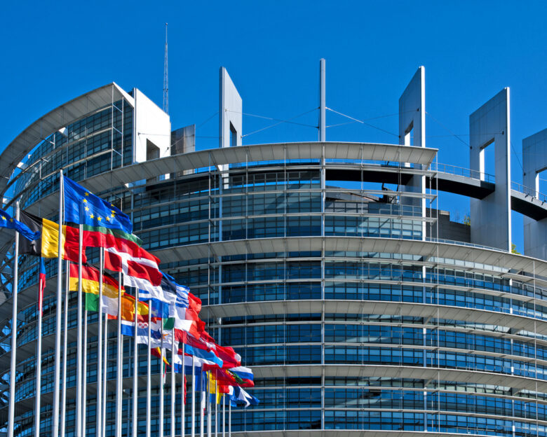The European Parliament building in Strasbourg, France with flags waving calmly celebrating peace of the Europe.
