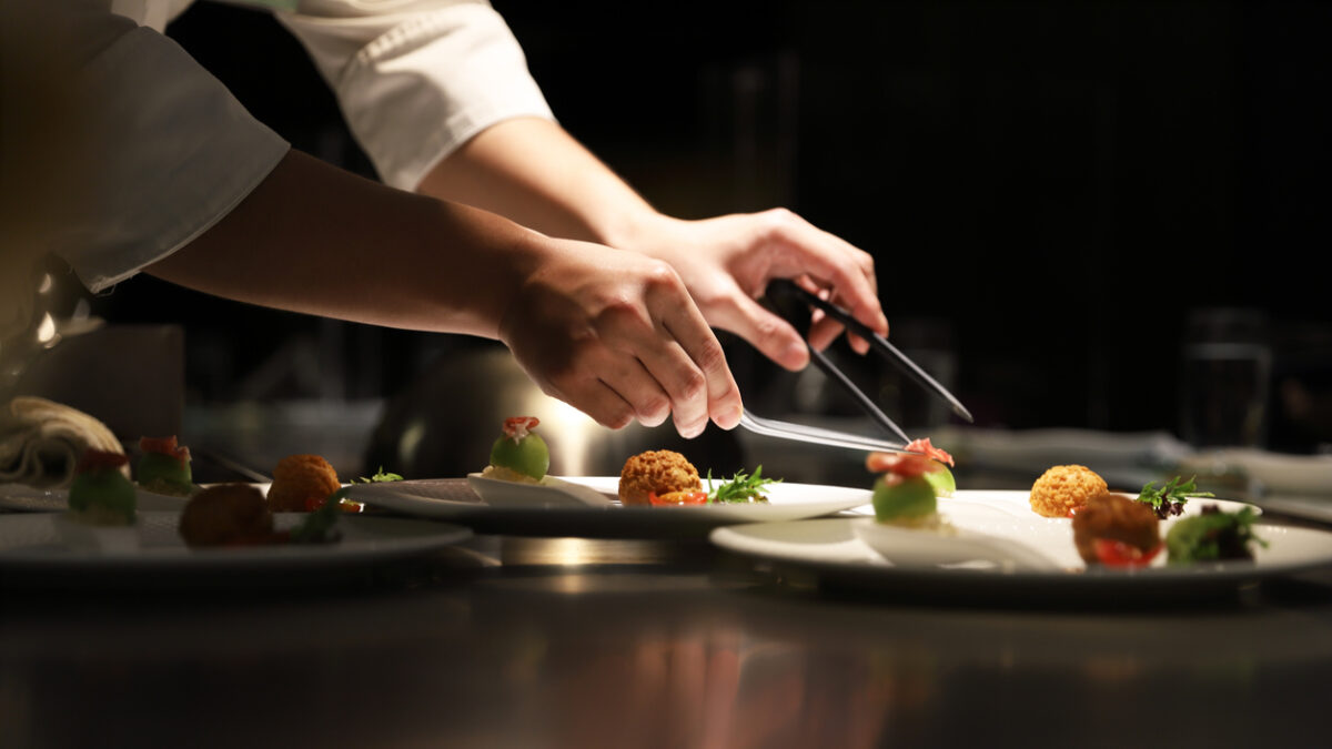 Teppanyaki chef cooking in front of guests.
