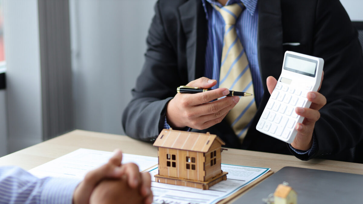 Real estate agent discussing about the terms of the purchase agreement and sign the documents to make the contract legally. Home sales, renting, leasing, mortgage and home insurance concept