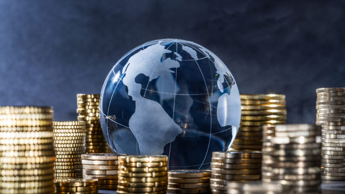 Globe and stack with coins. Money makes the world go round
