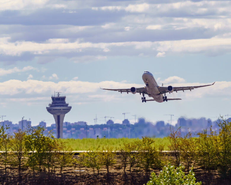 Great plane taking off and taking height next to the control tower of the airport, Madrid, Spain