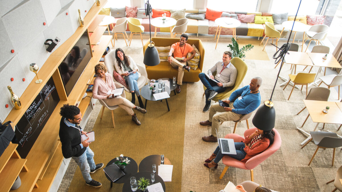 High angle view on a diverse group of business people at a business meeting. Middle Eastern businessman presenting data.