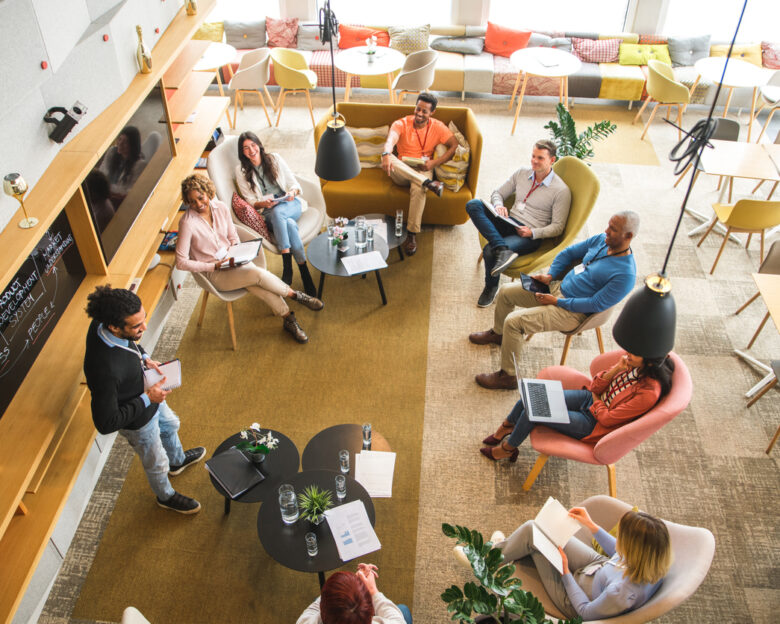 High angle view on a diverse group of business people at a business meeting. Middle Eastern businessman presenting data.