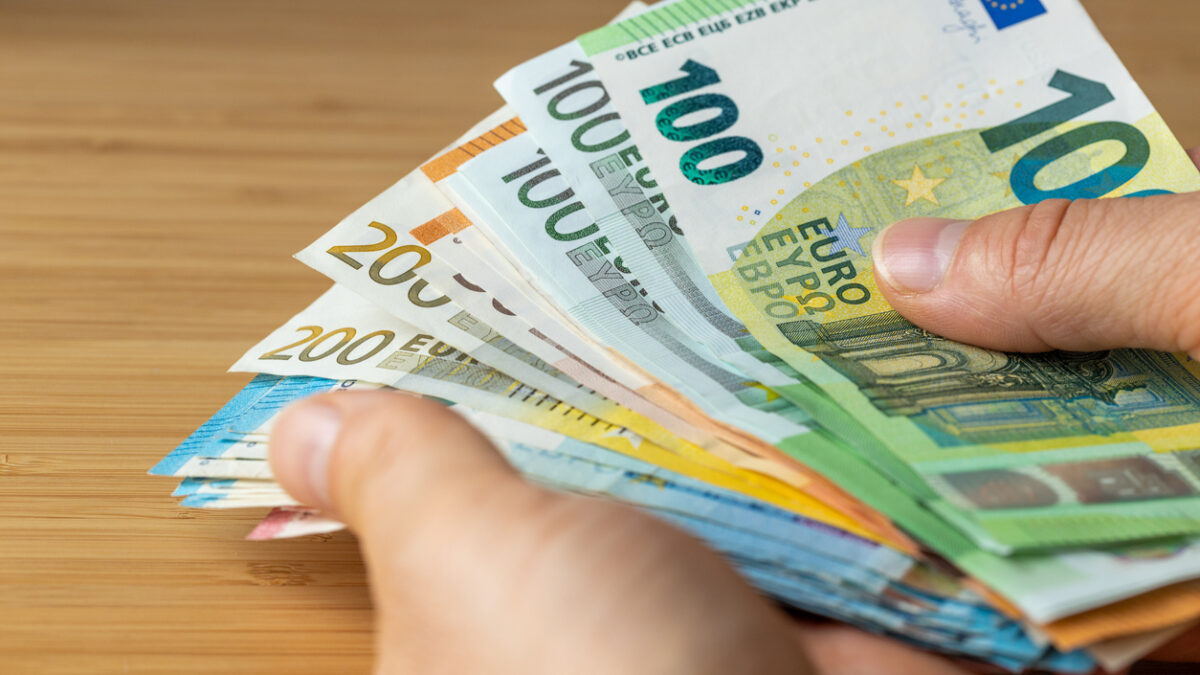 Bundles of euro money, bundle of banknotes held in a hand, Financial concept, Euro zone, Currency of the European Union