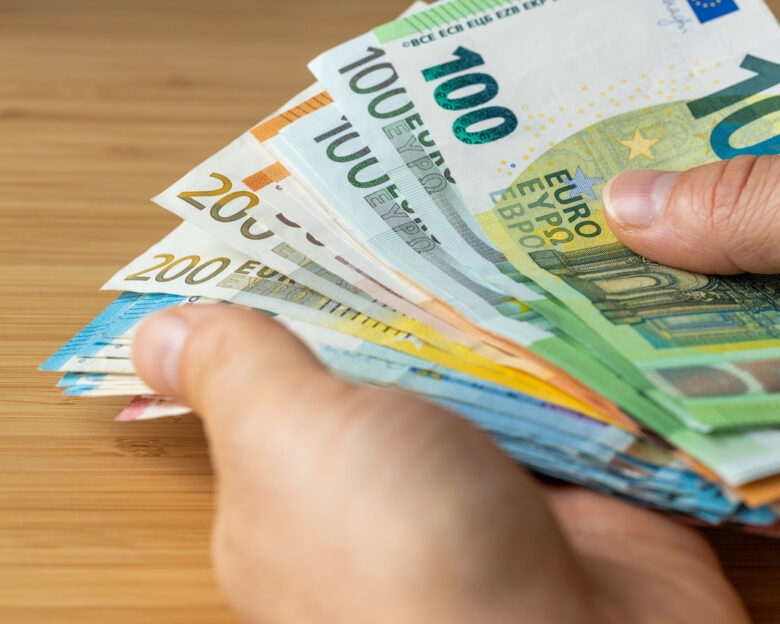 Bundles of euro money, bundle of banknotes held in a hand, Financial concept, Euro zone, Currency of the European Union