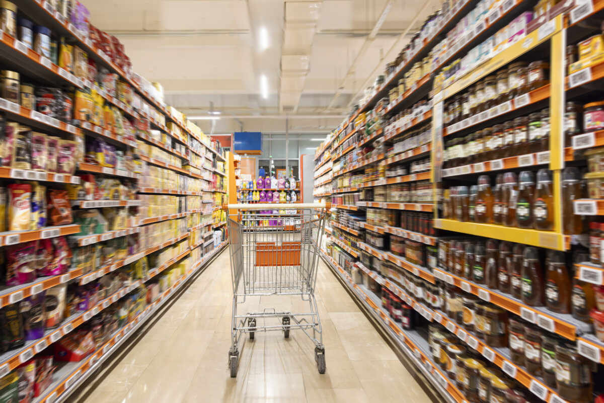 Empty cart in supermarket aisle