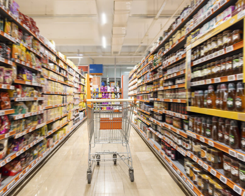 Empty cart in supermarket aisle