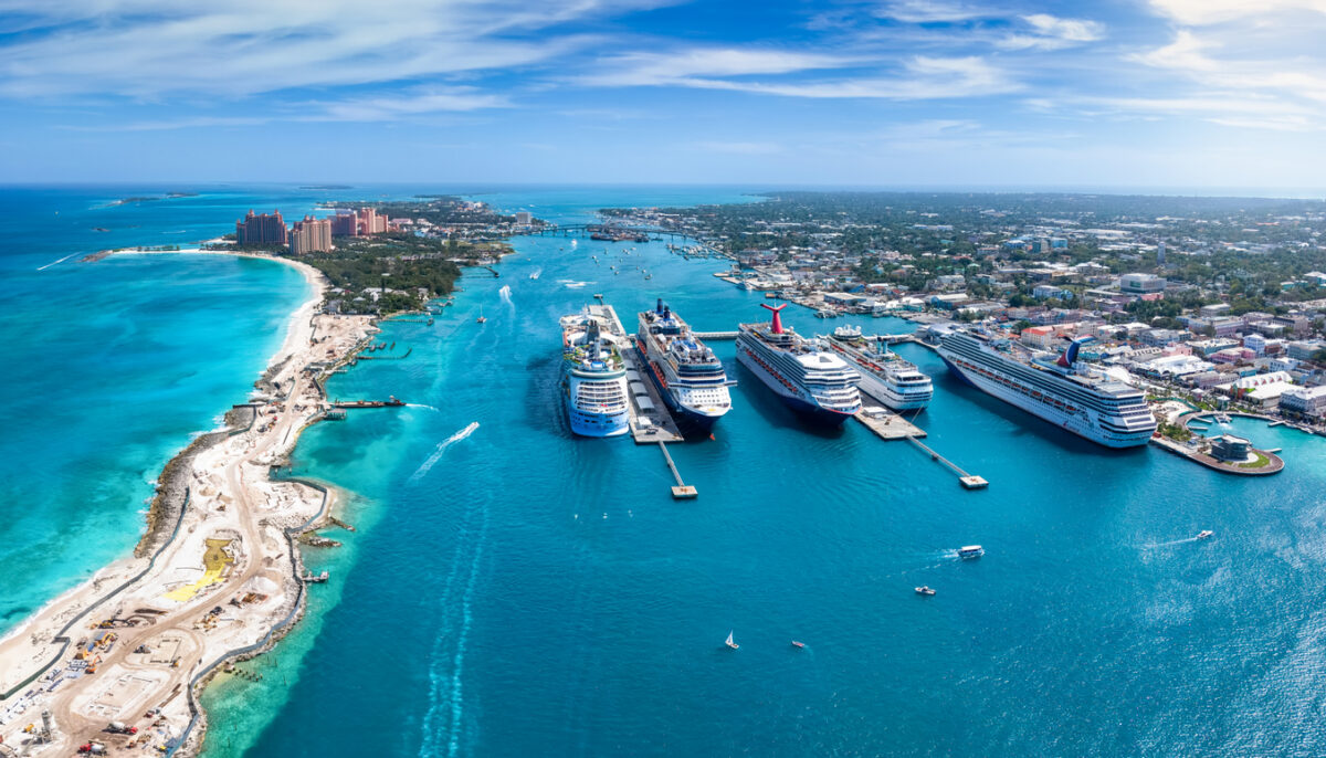 Panoramic aerial view of the port of Nassau with numerous cruise ships lined up and beautiful Paradise island