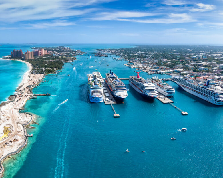 Panoramic aerial view of the port of Nassau with numerous cruise ships lined up and beautiful Paradise island