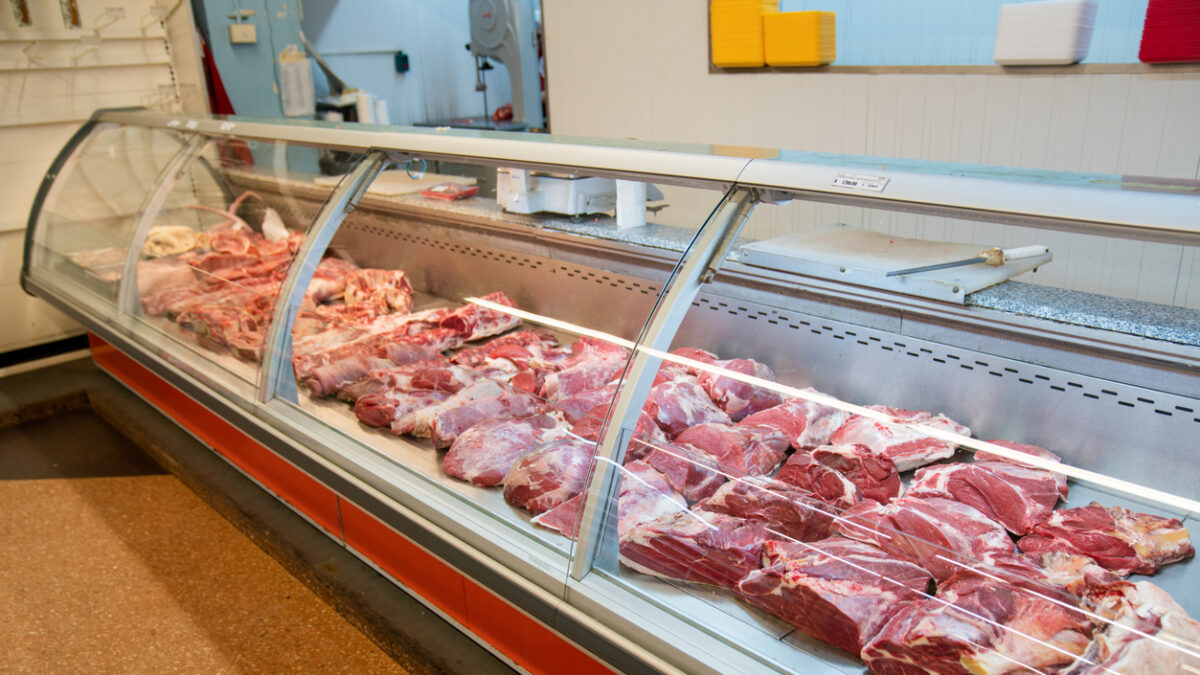 Assorted fresh meats neatly displayed in the butcher’s section of a supermarket store. Meat department in a supermarket