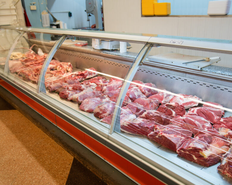 Assorted fresh meats neatly displayed in the butcher’s section of a supermarket store. Meat department in a supermarket