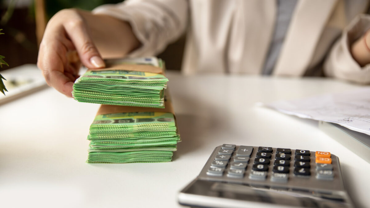 Unrecognizable Female account manager with euros, home budget documents, laptop and calculator in office or home workspace