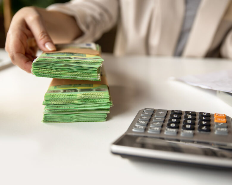 Unrecognizable Female account manager with euros, home budget documents, laptop and calculator in office or home workspace