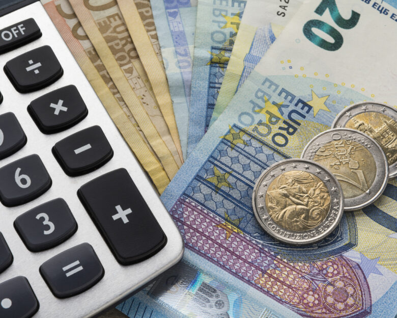 Close up of a calculator and euro money in a financial analyzing concept