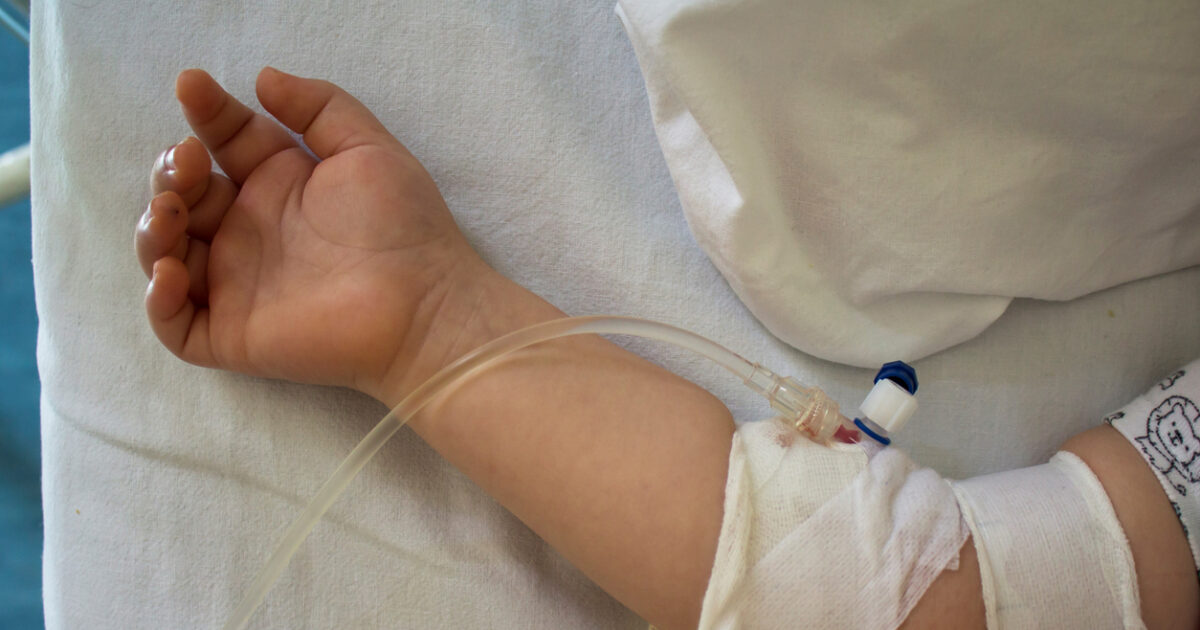 Little patient, child sick in the hospital with saline intravenous (IV).Close-up. Recovery,health care treatment.