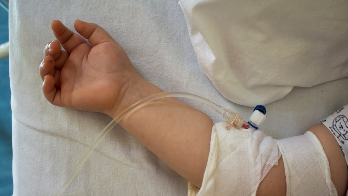 Little patient, child sick in the hospital with saline intravenous (IV).Close-up. Recovery,health care treatment.
