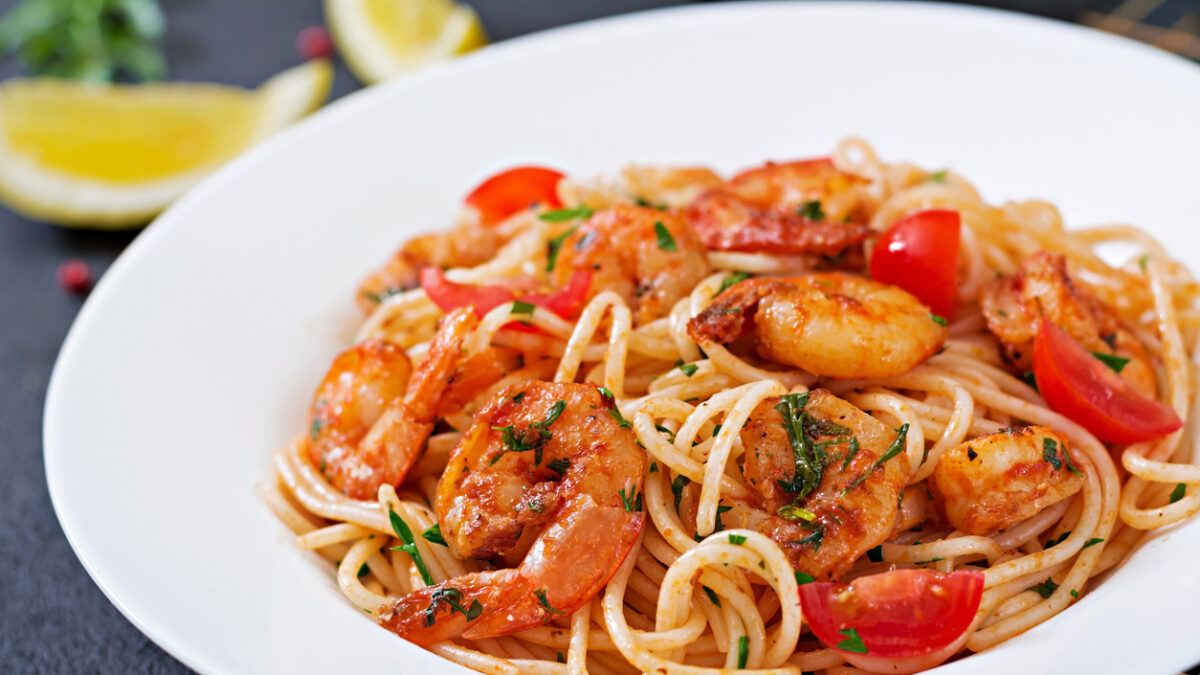 Pasta spaghetti with shrimps, tomato and parsley. Healthy meal. Italian food.