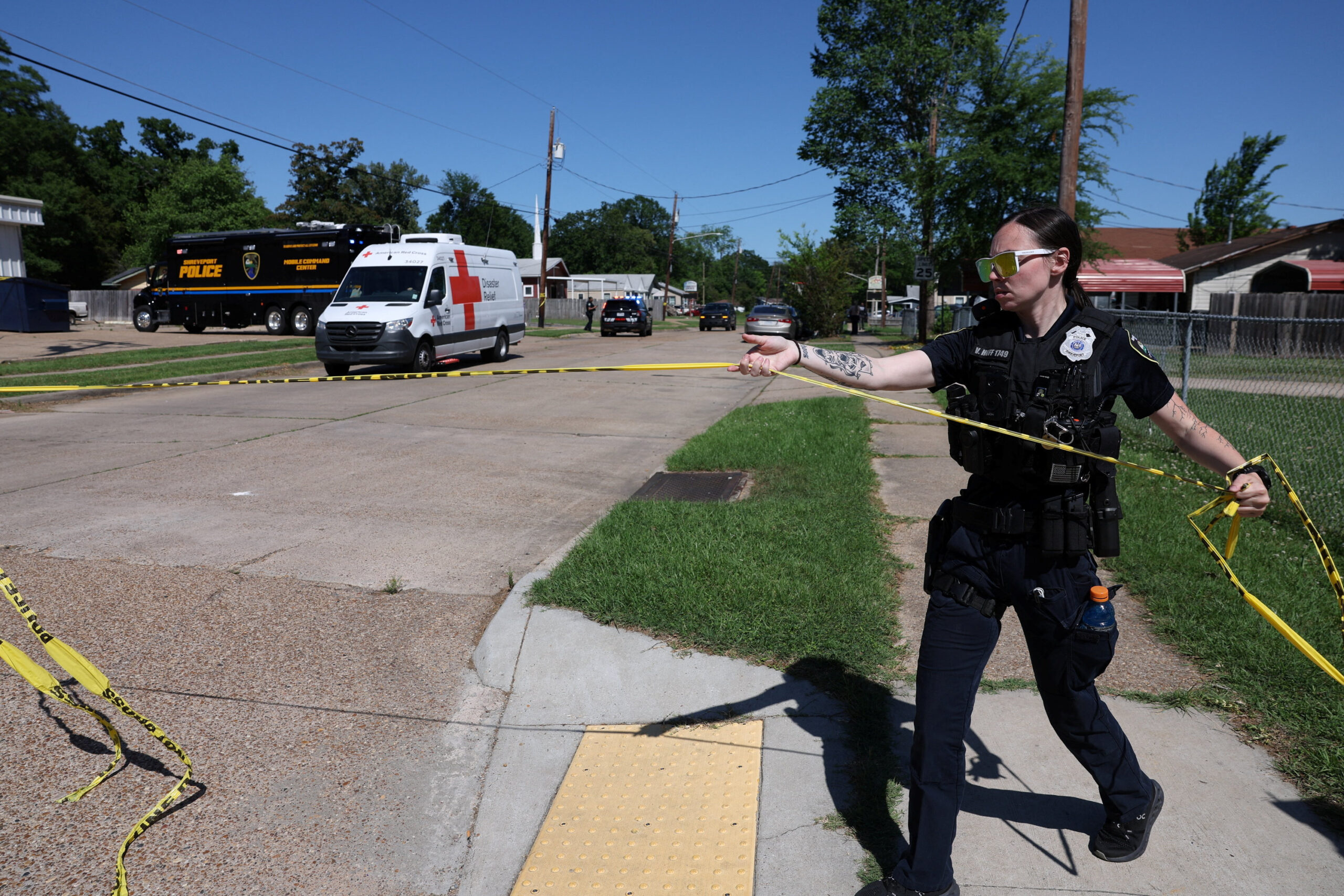 A Shreveport police officer works at the scene after children, with ages ranging from 1 to 14, were killed in a mass shooting incident described as domestic violence, in Shreveport, Louisiana, U.S. April 19, 2026. REUTERS/Kevin Bartram