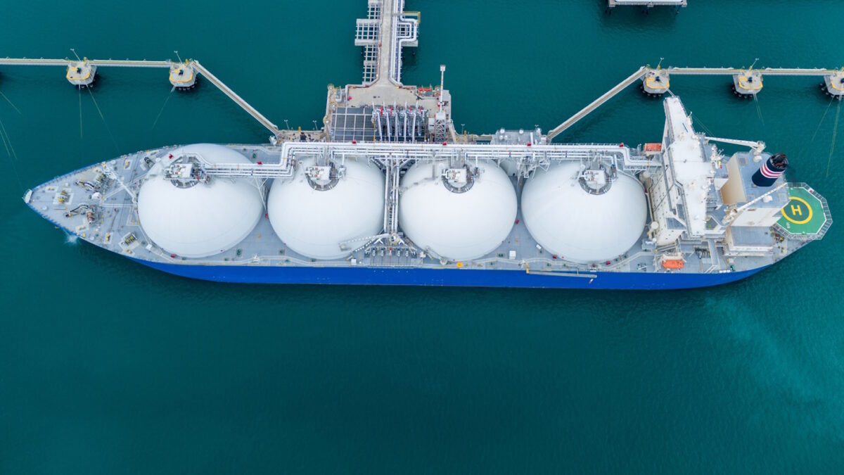 LNG (Liquefied natural gas) tanker anchored in Gas terminal gas tanks for storage. Oil Crude Gas Tanker Ship. LPG at Tanker Bay Petroleum Chemical or Methane freighter export import transportation