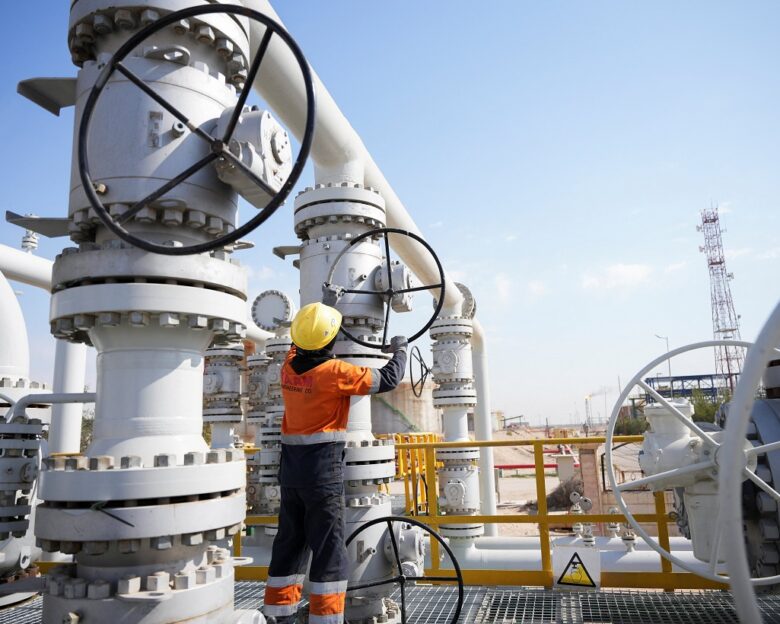 A worker operates valves at the Rumaila oil field, as the country cuts nearly 1.5 million barrels per day of output amid halted exports following the closure of the Strait of Hormuz, in Basra, Iraq, March 4, 2026.