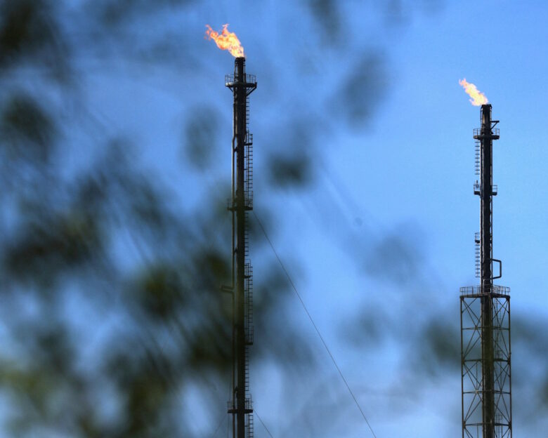 Flames come out of chimneys at a TotalEnergies hydrocarbones depot in Feluy, Belgium April 8, 2026. REUTERS/Yves Herman