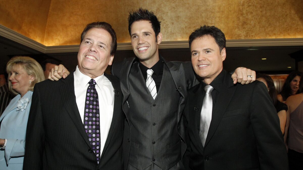 Actor Donny Osmond (R) poses with his brothers Alan (L) and David