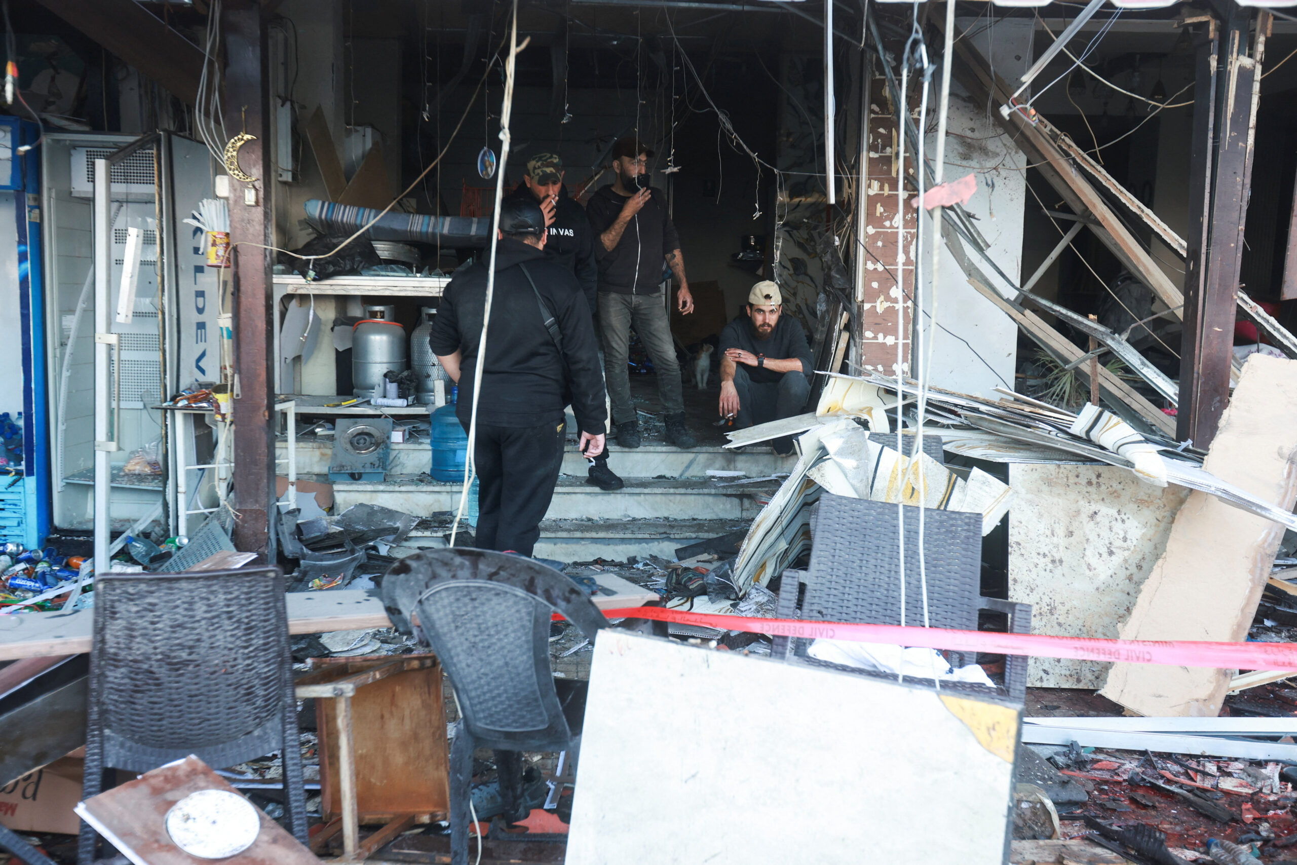 Aftermath of an Israeli strike in Sidon Men gather inside a cafe damaged in the aftermath of an Israeli strike in Sidon, Lebanon, April 8, 2026. REUTERS/Aziz Taher