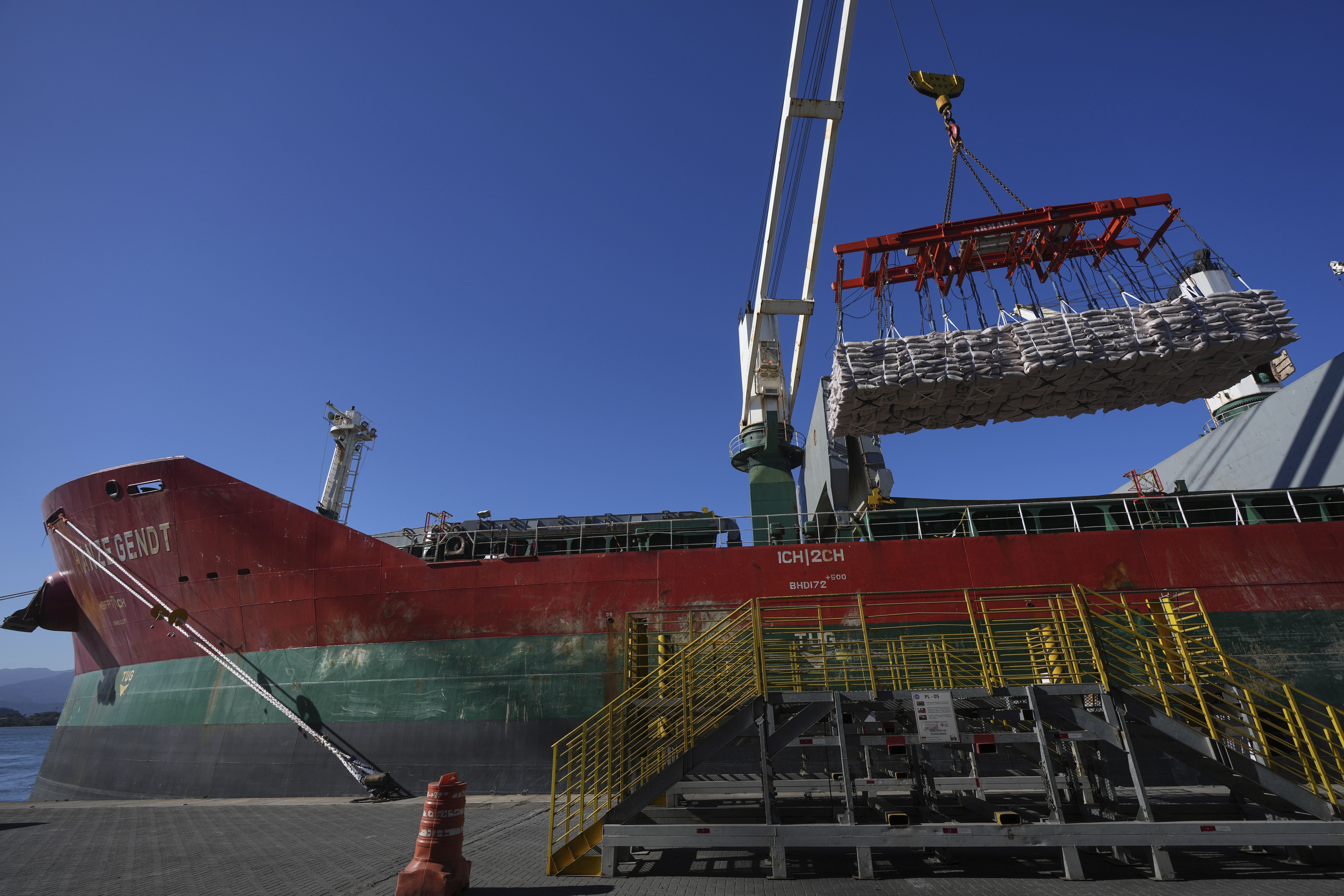Bulk bags of sugar are lifted by a crane to be loaded on a container ship at the port of Santos, Brazil, Tuesday, July 29, 2025. (AP Photo/Andre Penner)