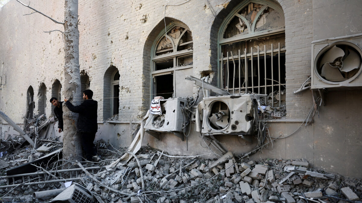People stand amidst the rubble of a building of the Sharif University of Technology, which was damaged in a strike, amid the U.S.-Israeli conflict with Iran, in Tehran, Iran, April 7, 2026. Majid Asgaripour
