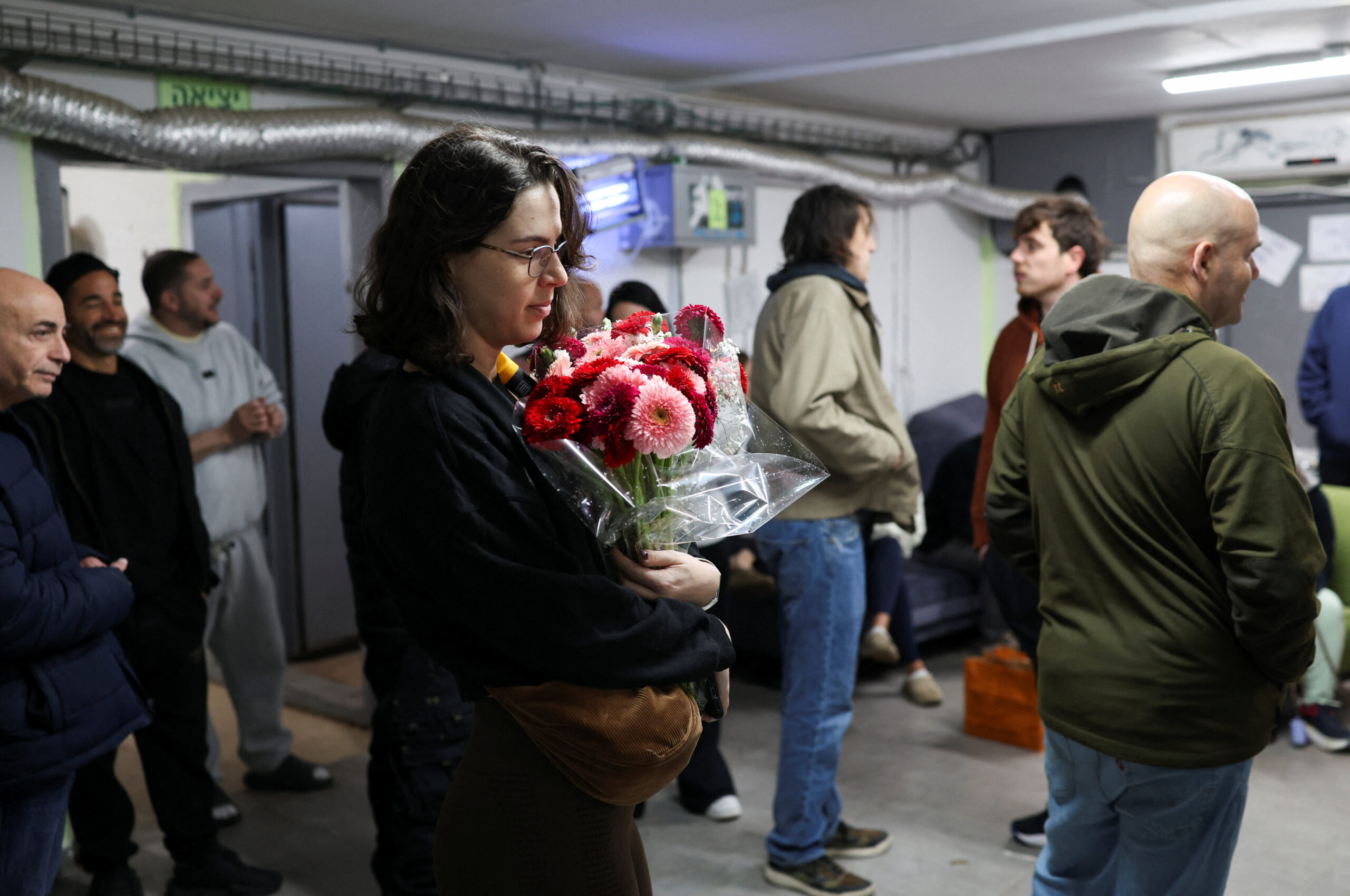 People at a shelter, after Iran launched missiles towards Israel, amid the U.S.-Israel conflict with Iran, in Tel Aviv A woman holds a bouquet of flowers as people gather at a shelter, after Iran launched missiles towards Israel, amid the U.S.-Israel conflict with Iran, in Tel Aviv, Israel April 1, 2026. REUTERS/Ronen Zvulun