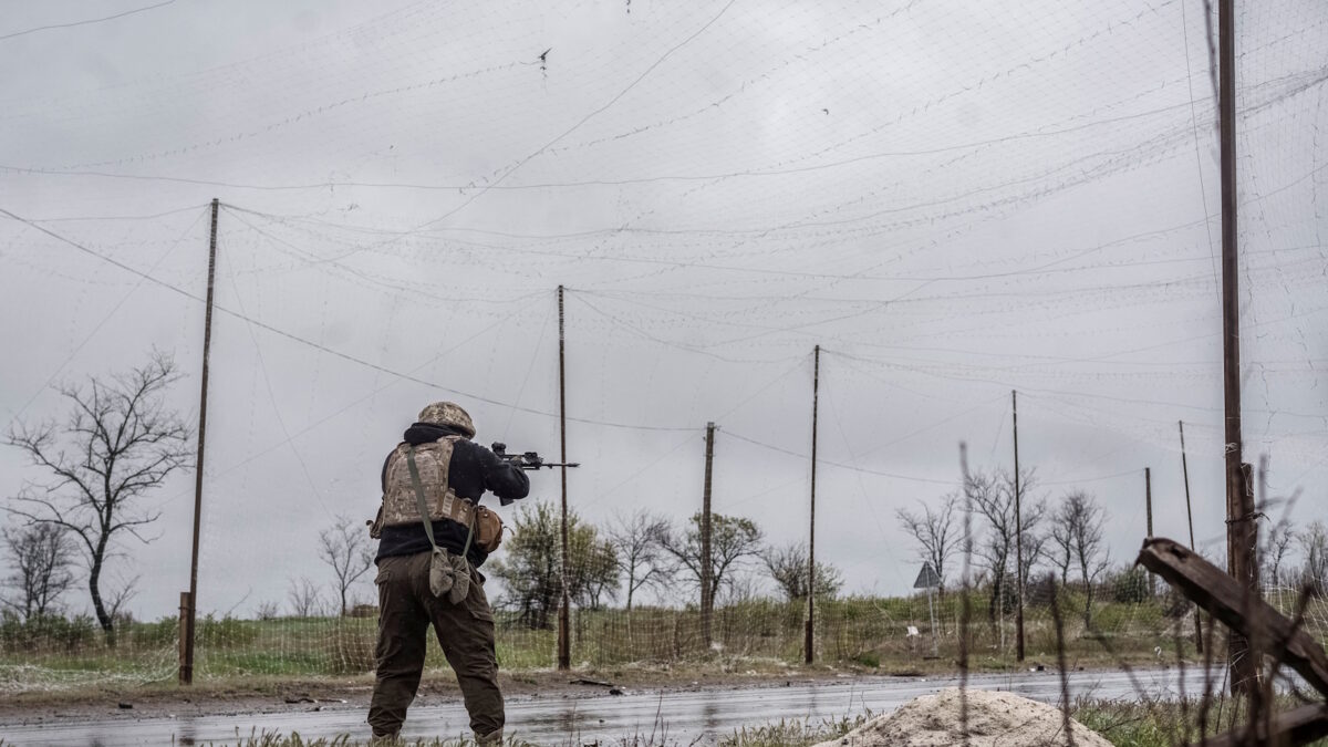 A serviceman of the 24th Separate Mechanized Brigade of the Ukrainian Armed Forces fires an assault rifle to shoot down a Russian drone during a mission to protect streets in the frontline town of Druzhkivka, amid Russia's attack on Ukraine, in Donetsk region, Ukraine April 24, 2026. REUTERS