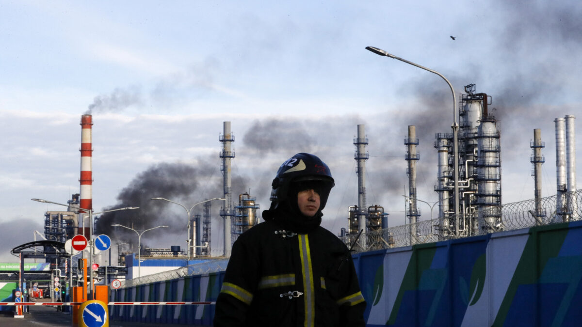 FILE PHOTO: A firefighter is seen on a site, as smoke billows from a fire at oil refinery, owned by Russian oil producer Gazprom Neft, in Moscow, Russia, November 17, 2018. REUTERS/Tatyana Makeyeva/File Photo