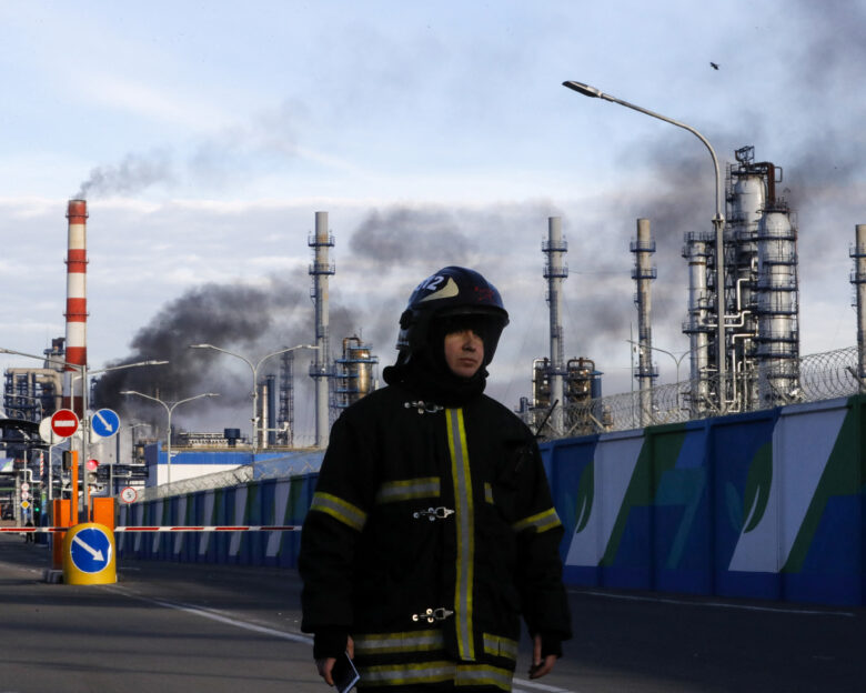 FILE PHOTO: A firefighter is seen on a site, as smoke billows from a fire at oil refinery, owned by Russian oil producer Gazprom Neft, in Moscow, Russia, November 17, 2018. REUTERS/Tatyana Makeyeva/File Photo