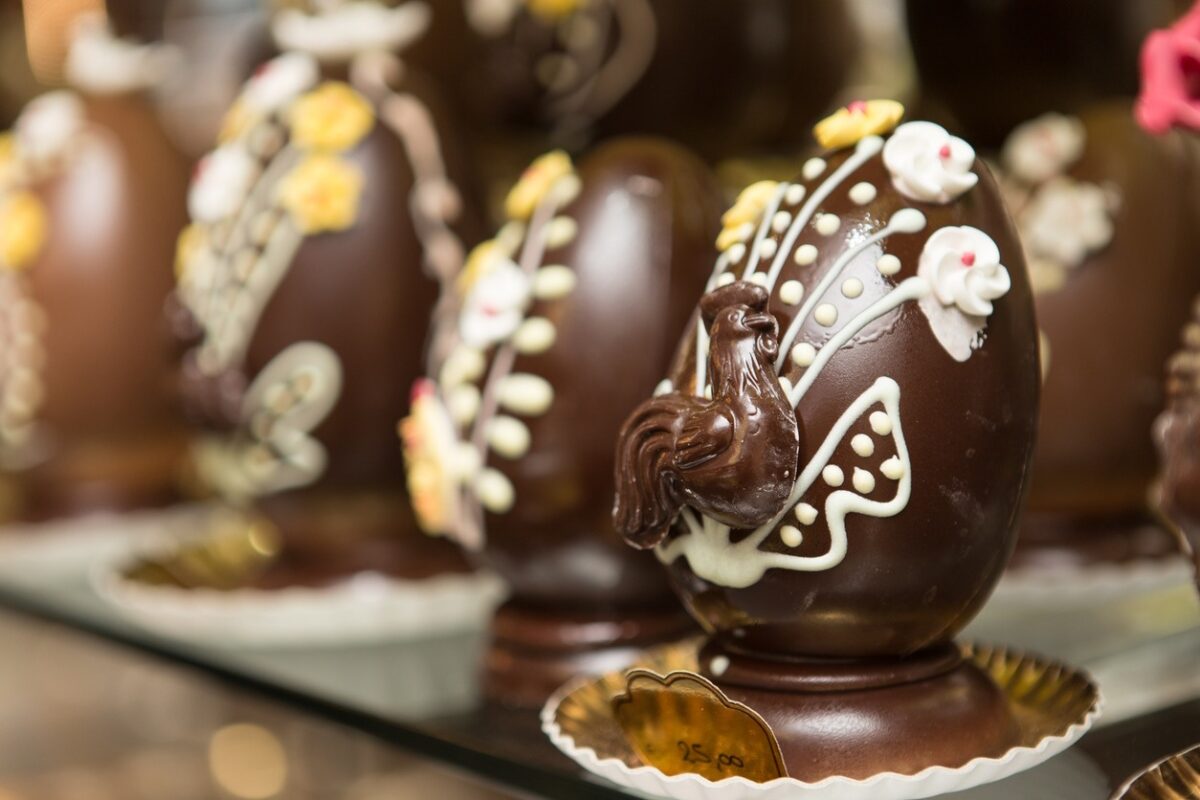 Close up on chocolate easter egg ornate with chocolate carvings.