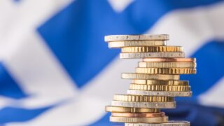 National flag of greece and euro coins - concept. Euro coins. Euro money. Euro currency.