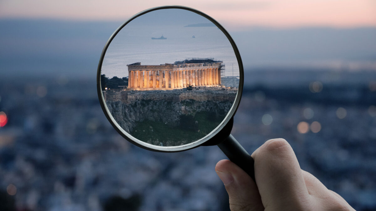 A magnifying glass over the Parthenon building in Athens, Greece