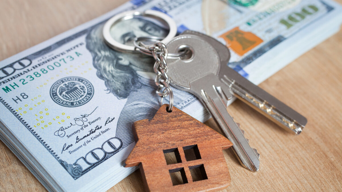 Real estate investing concept. American dollar, cash or housing. Keys close-up